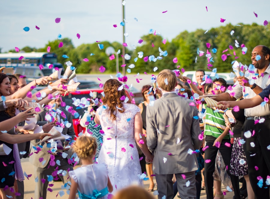 Newlyweds walking through a confetti send-off surrounded by guests